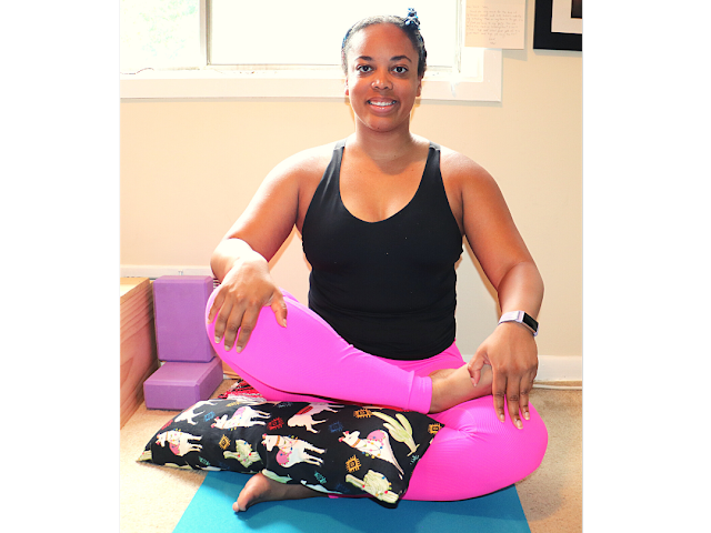 This photo features my pranayama yoga bolster being used for support in fire log pose.